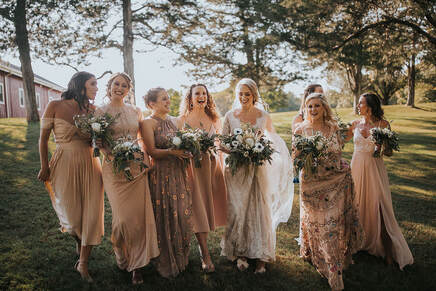 bride with bridesmaids is mismatched dresses