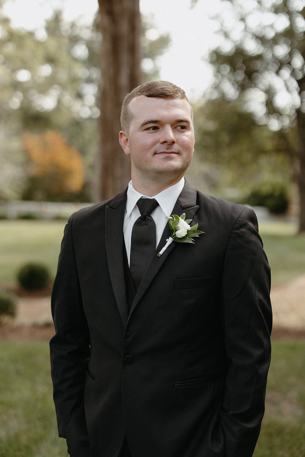 Groom Portrait with White and Green Boutonniere