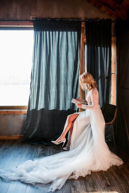 bride reads personal vows in front of big window