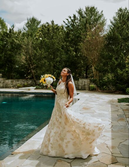 bride twirls in sparkly gown beside the pool