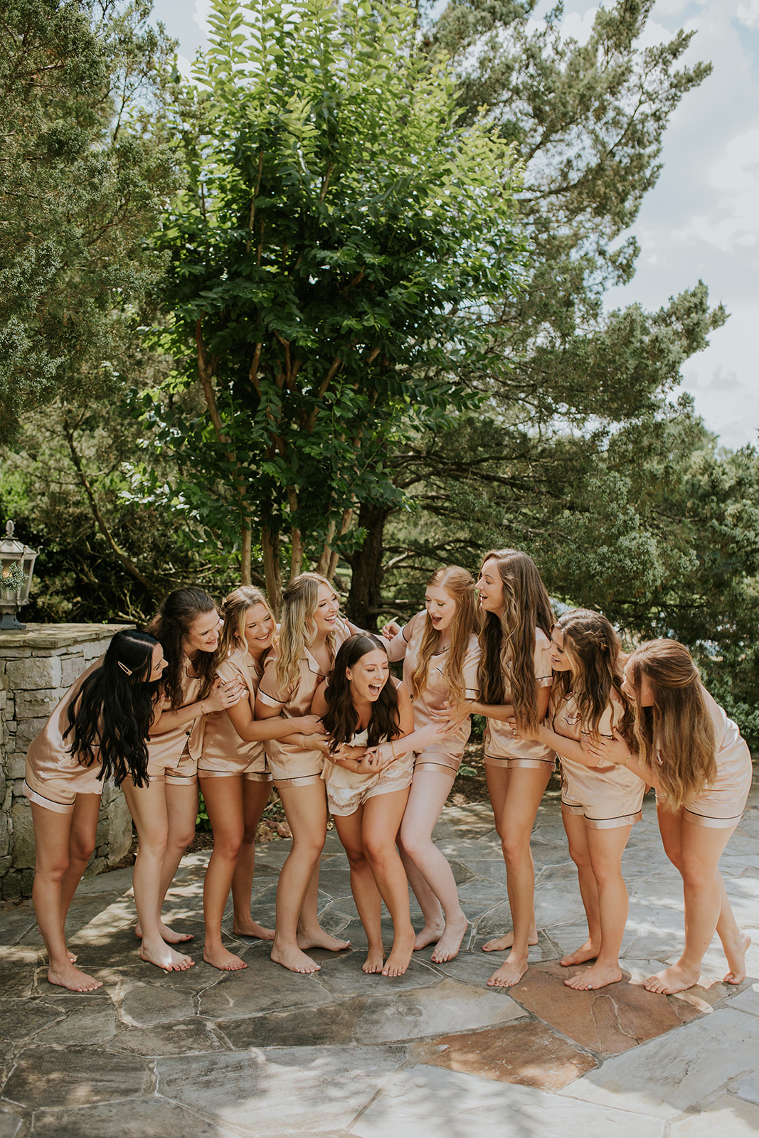 bride surrounded by bridesmaids in matching pajamas