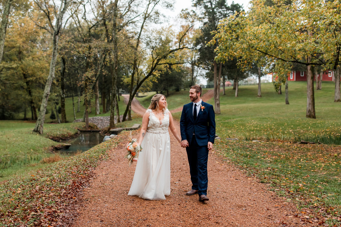 couple posed on country road at farm wedding venue