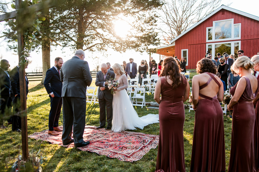 wedding ceremony with Cedarmont Farm barn in the background