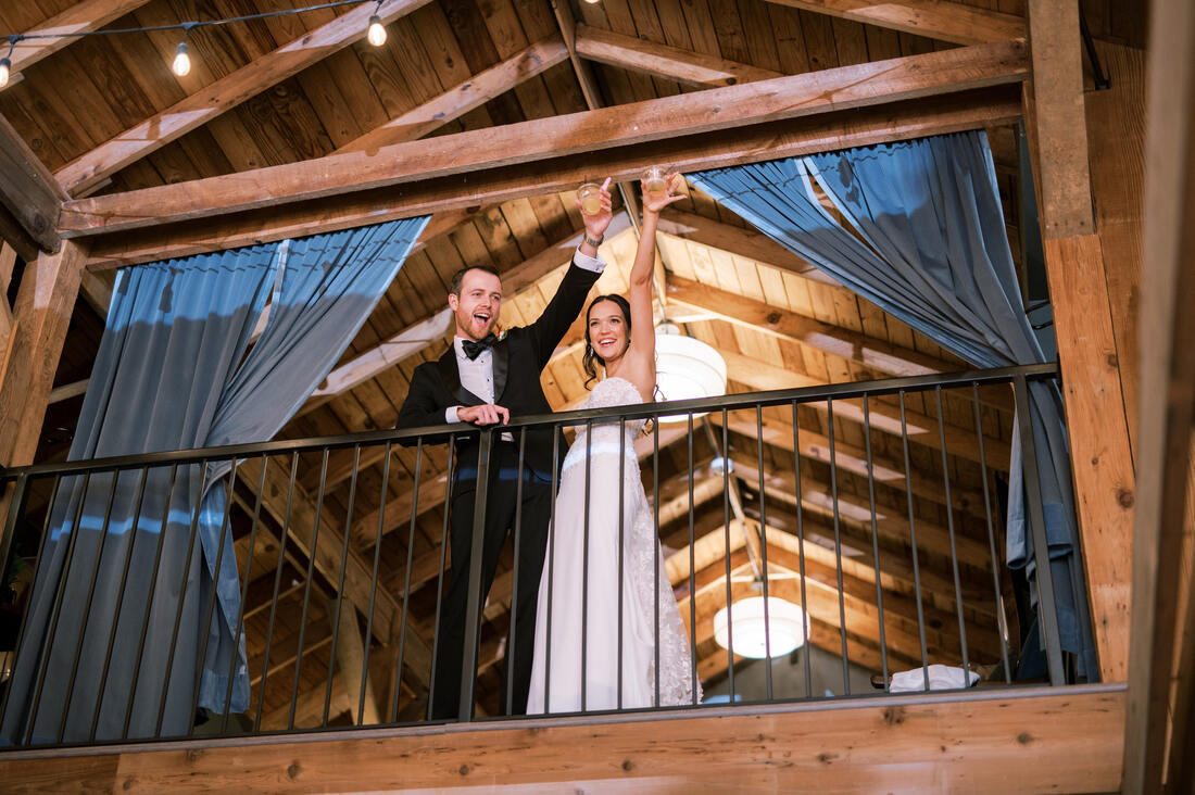 Bride and Groom Toasting from Balcony at Cedarmont Farm