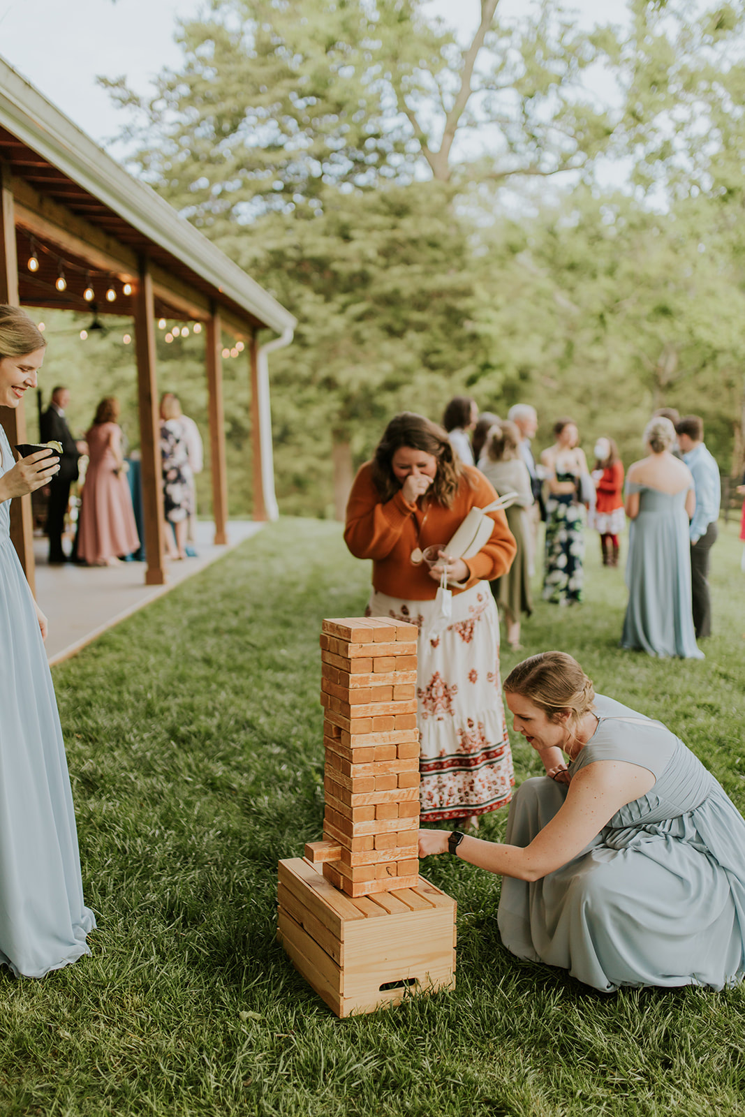 guests play giant Jenga at wedding reception